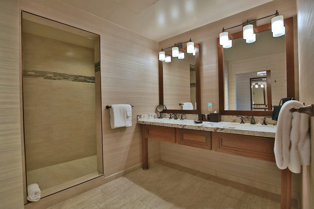 Spacious bathroom in a guest accommodation at Vintners Resort, featuring double vanity and an oversized walk-in shower.