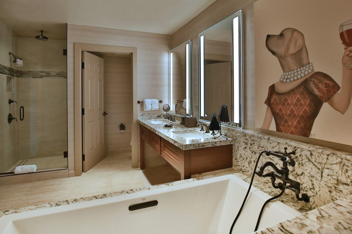 Spacious bathroom in a guest accommodation at Vintners Resort, featuring a deep soaking tub, double vanity, an oversized walk-in shower, and separate water closet.