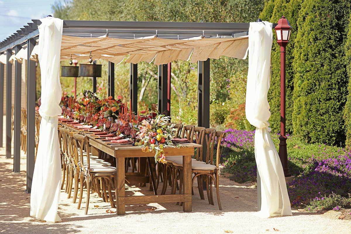 Set admist the vines and under a canopy, the outdoor Vineyard Table at Vintners Resort.