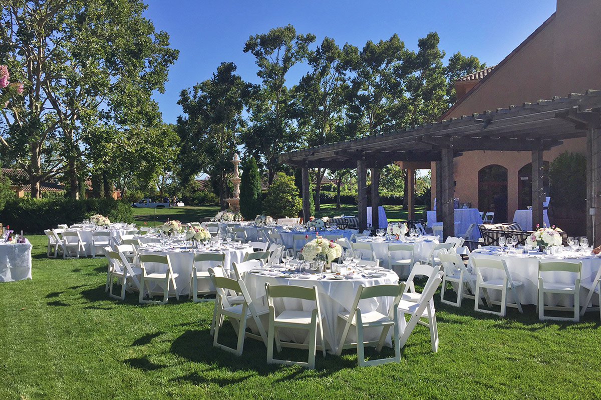 White banquet tables set on the Rose Lawn and Terraace for an outdoor event.