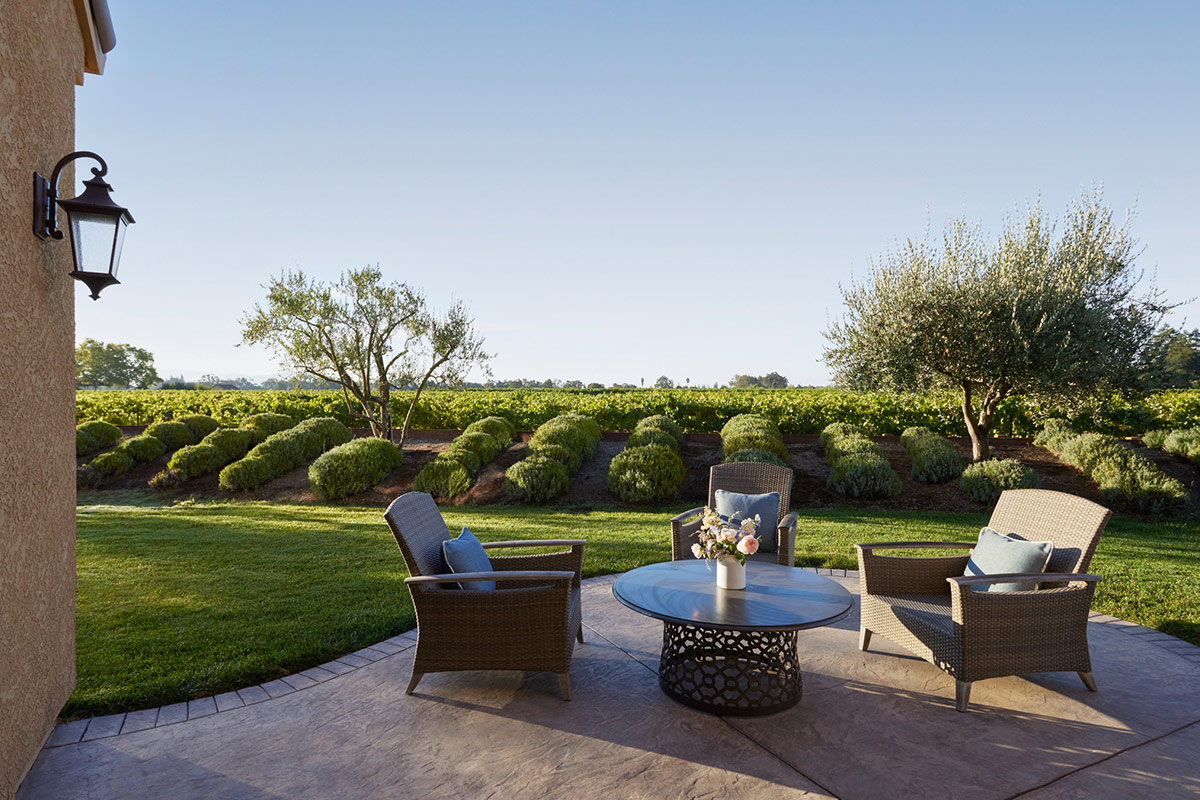 Overlooking the lavender fields and vineyards, the large terrace of Vineyard Terrace Deluxe Suite at Vintners Resort, with seating for four.