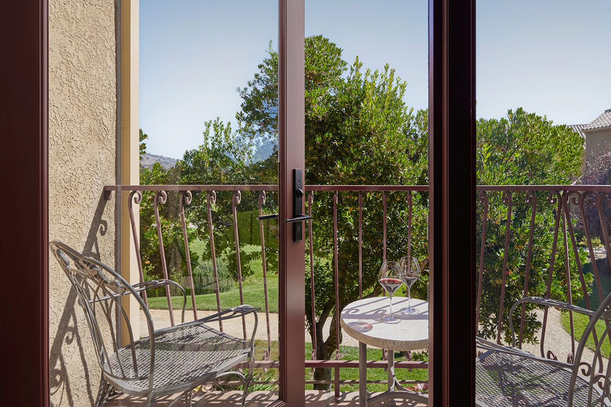 Furnished balcony on the second floor of Vintners Resort's guest acommodations, overlooks meticulous gardens.